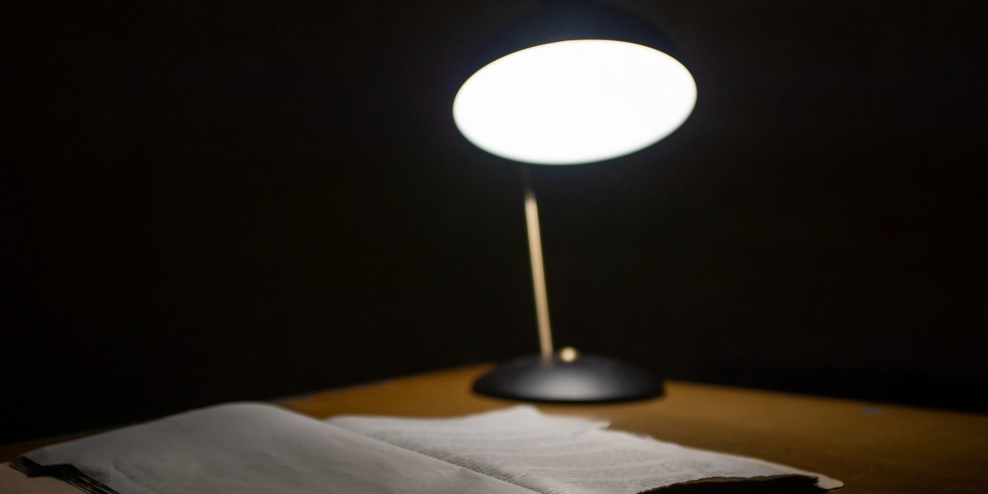 lamp on desk in a dark room