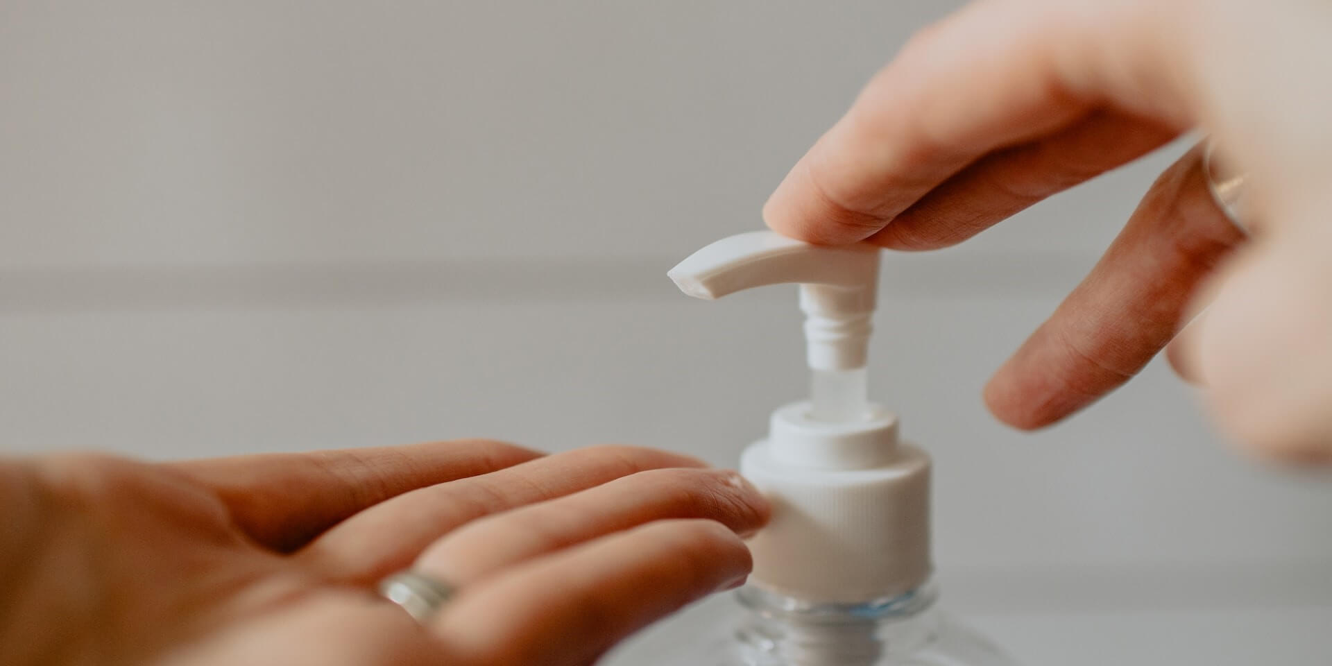 close up of someone putting hand sanitizer on their hands