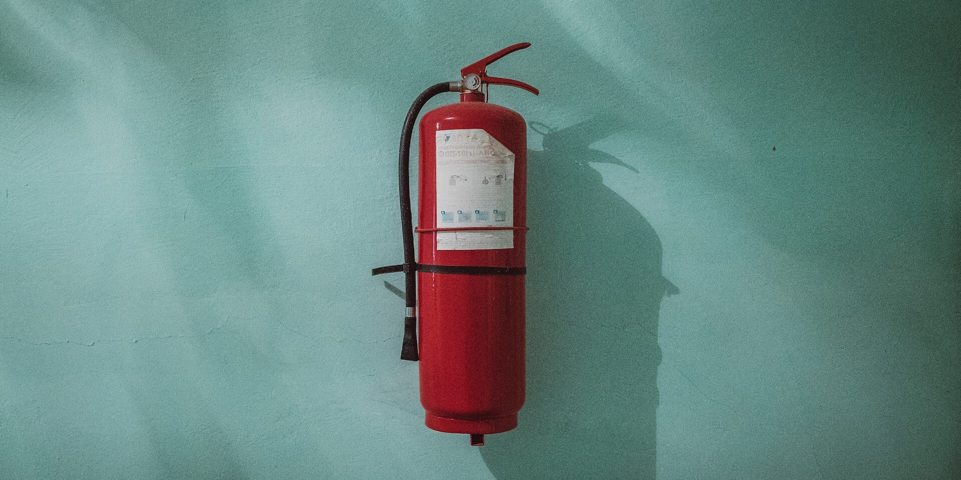 red fire extinguisher on a blue background